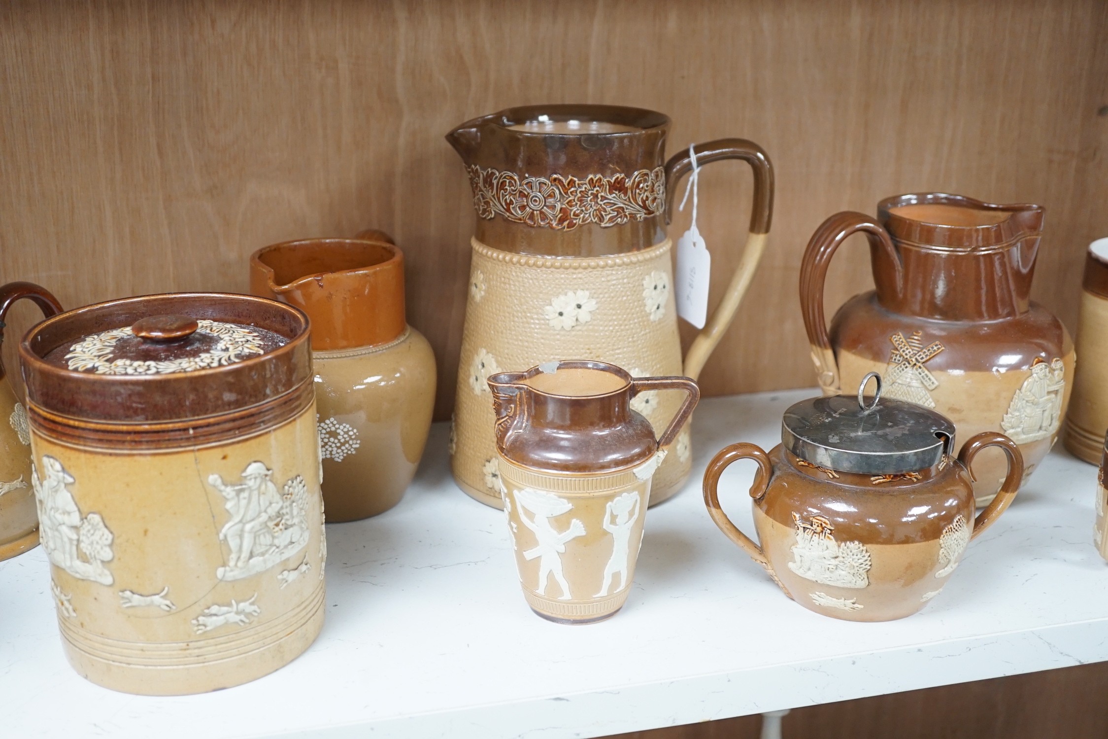 A group of Doulton stoneware jugs, storage jar, beakers, bowls etc